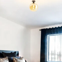 Straluma Mat zwarte plafondlamp met amber glazen bol 30 cm><noscript><img width=